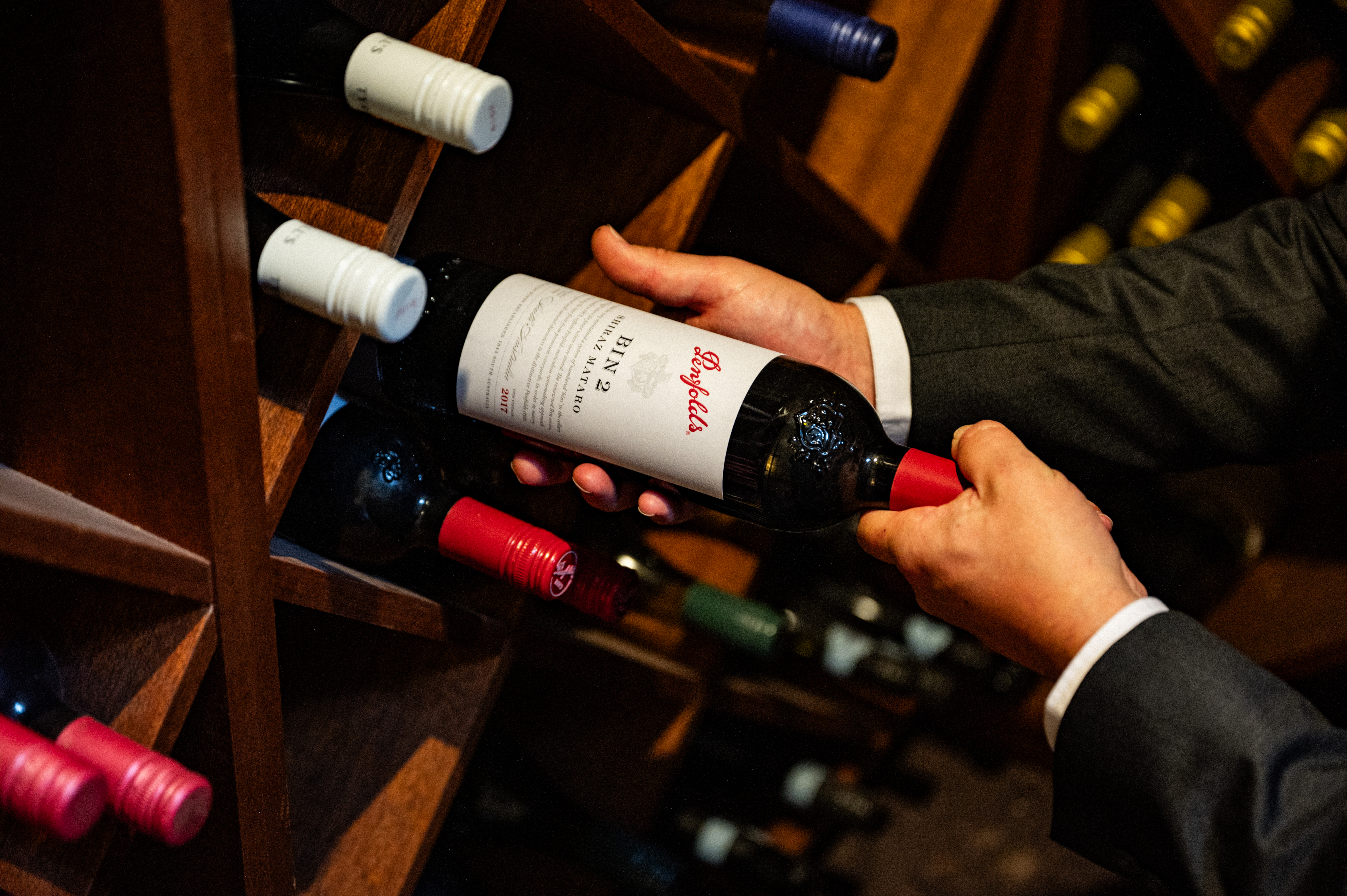 A glass of red wine being poured